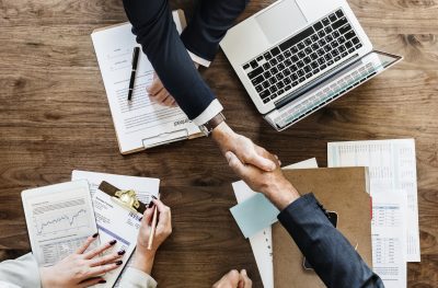 business-people-shaking-hands-together (1)-min
